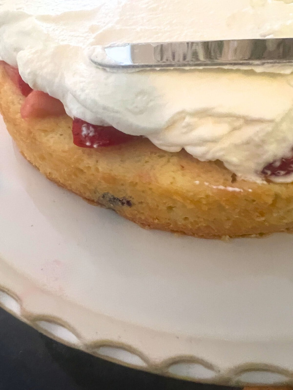 Berry pound cake layer, topped with strawberries and cream.