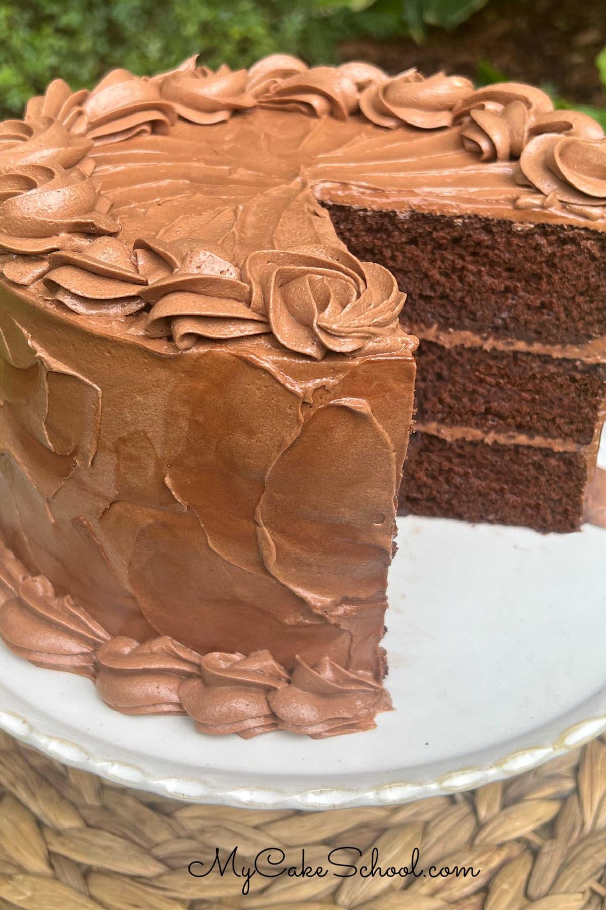 Sliced Gluten Free Chocolate Cake on a cake pedestal.