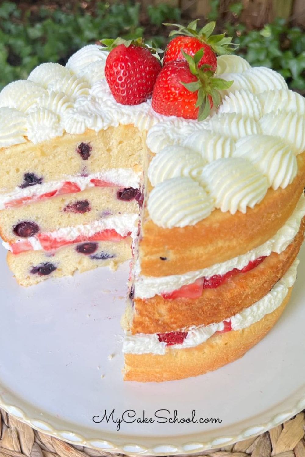 Berry Pound Cake, sliced, on a pedestal.