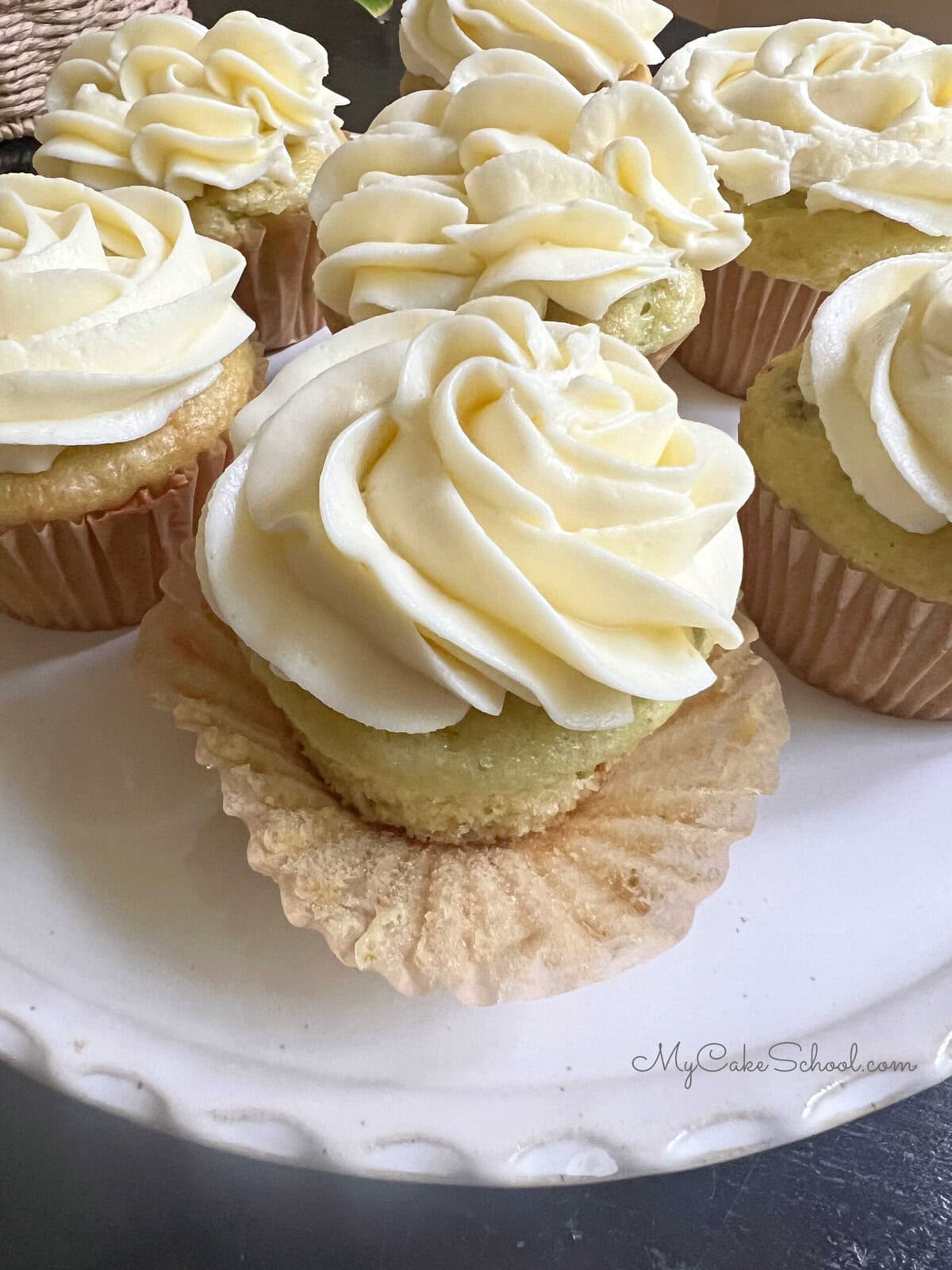Pistachio Cupcakes on a pedestal.
