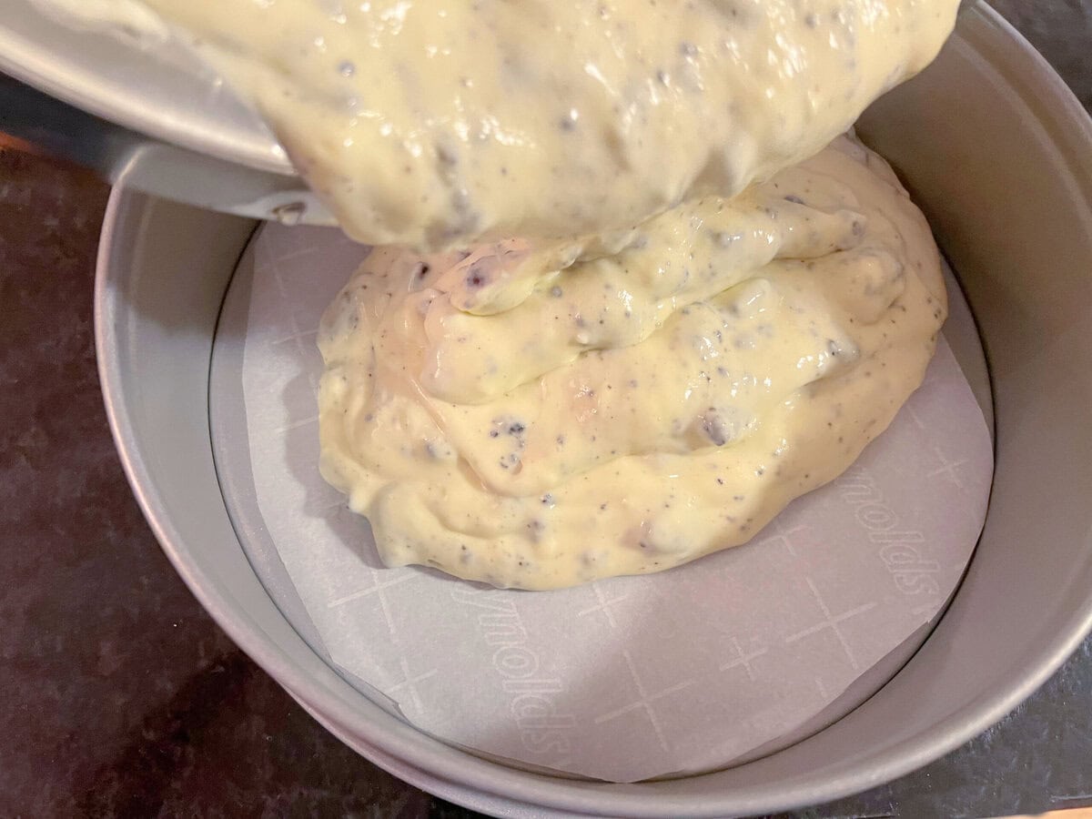 Pouring batter of cheesecake layer.