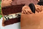 Oreo Cheesecake Cake, sliced, on a pedestal.