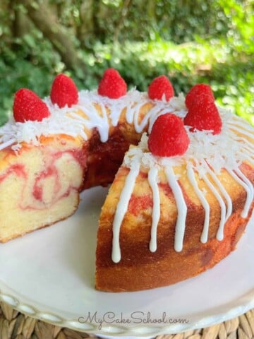 Raspberry Coconut Pound Cake on a pedestal.