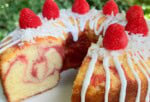 Raspberry Coconut Pound Cake, sliced, on a pedestal.