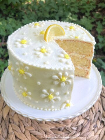 White Chocolate Lemon Cake on a pedestal.