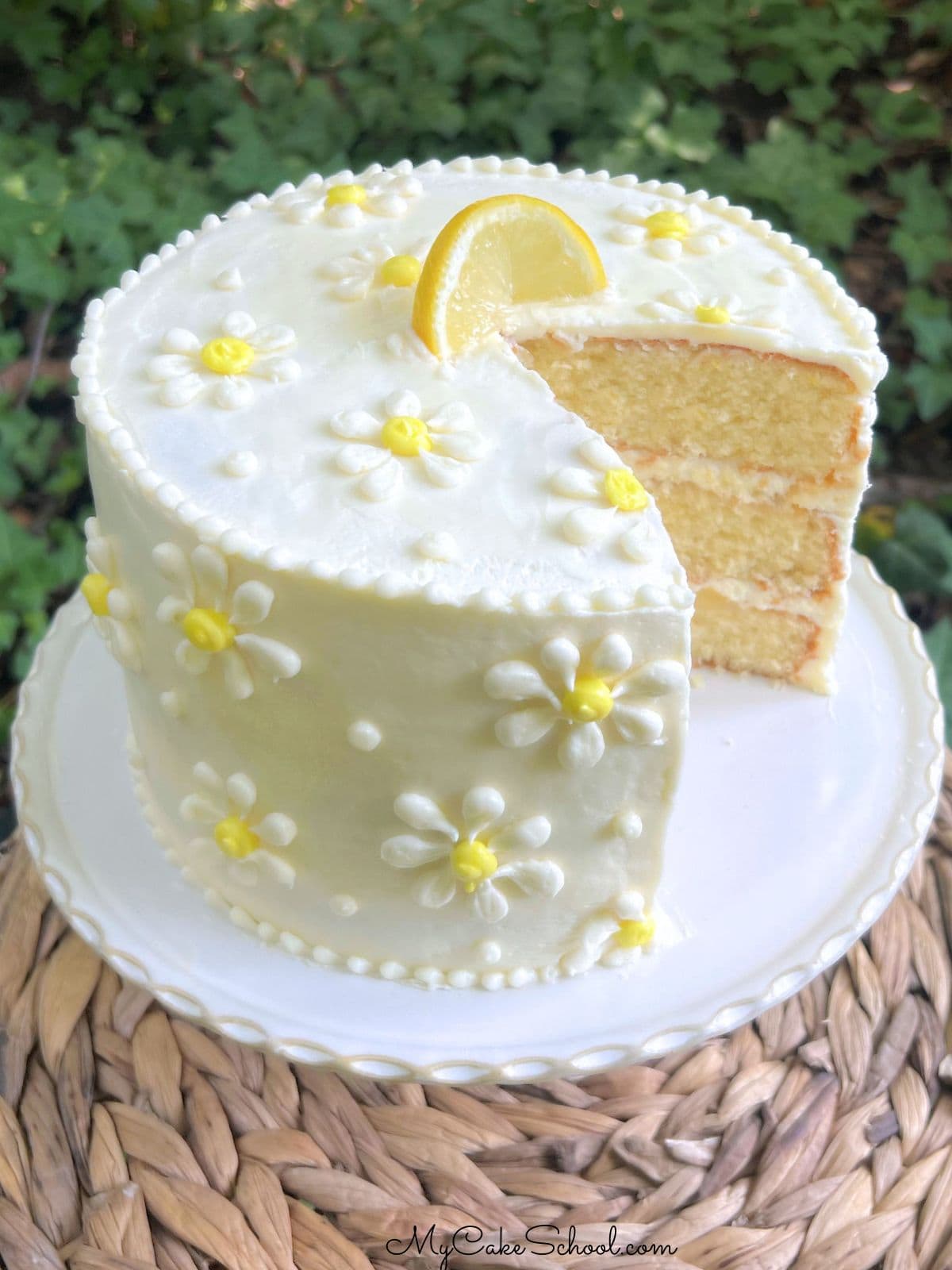 White Chocolate Lemon Cake on a pedestal.