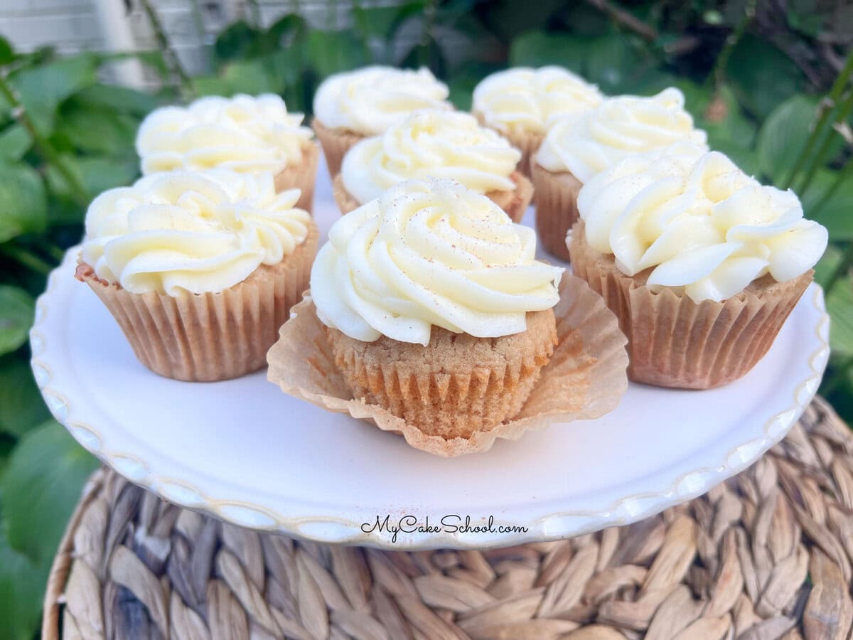 Frosted Apple Spice Cupcakes on a pedestal.