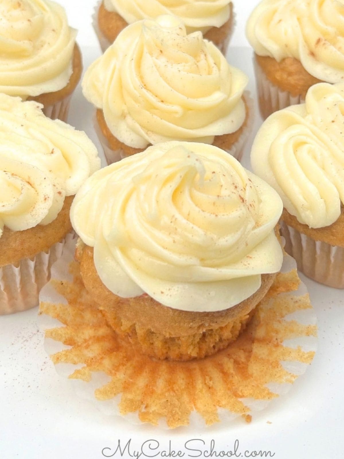 Moist Pumpkin Cupcakes on a cake platter.