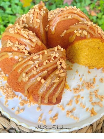 Easy Pumpkin Spice Bundt Cake, sliced, on a pedestal.