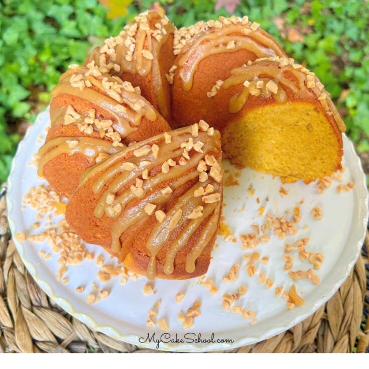 Easy Pumpkin Spice Bundt Cake, sliced, on a pedestal.