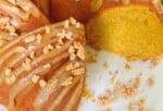 Easy Pumpkin Bundt Cake, sliced, on a pedestal.