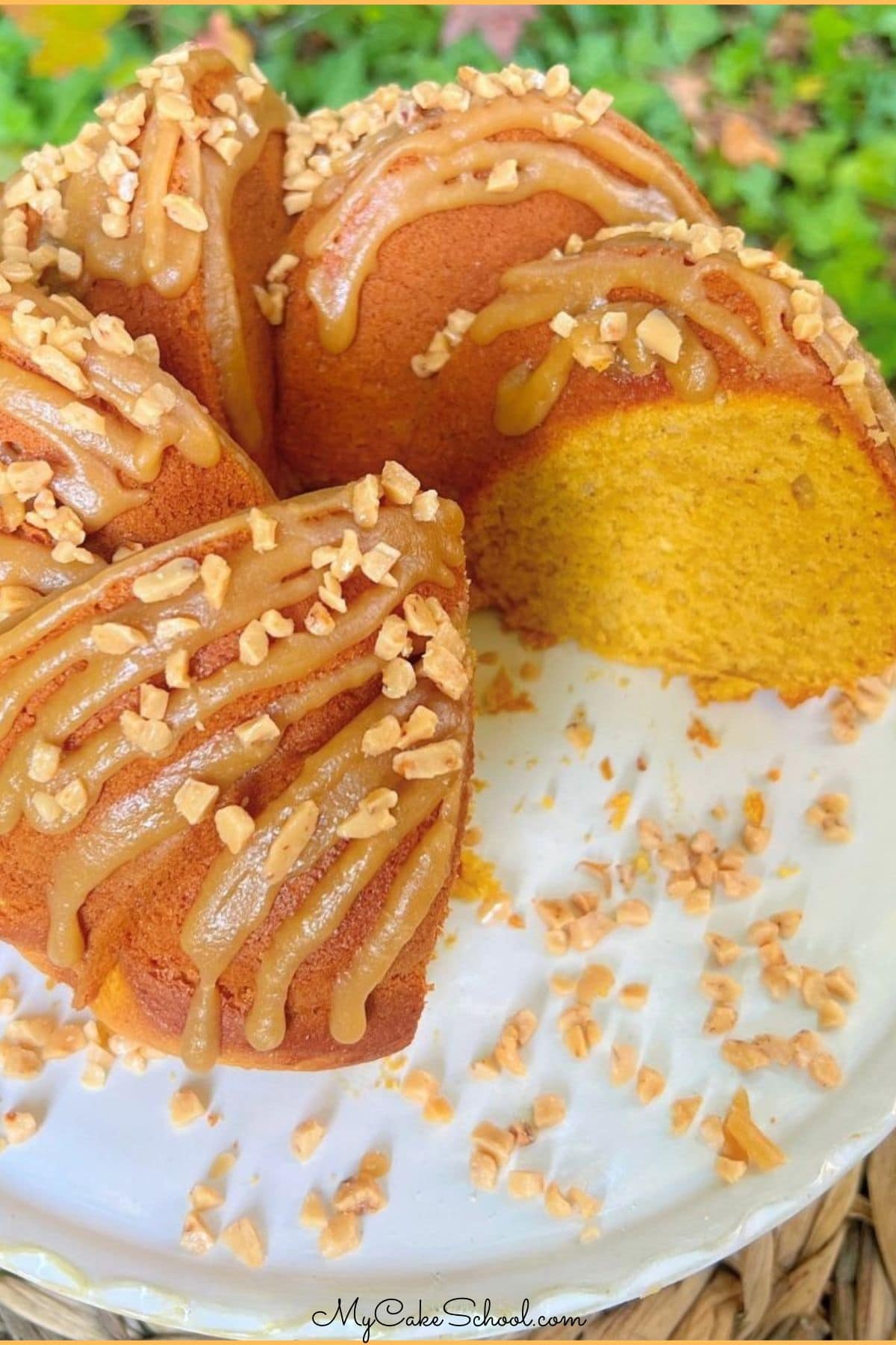 Easy Pumpkin Bundt Cake, sliced, on a pedestal.