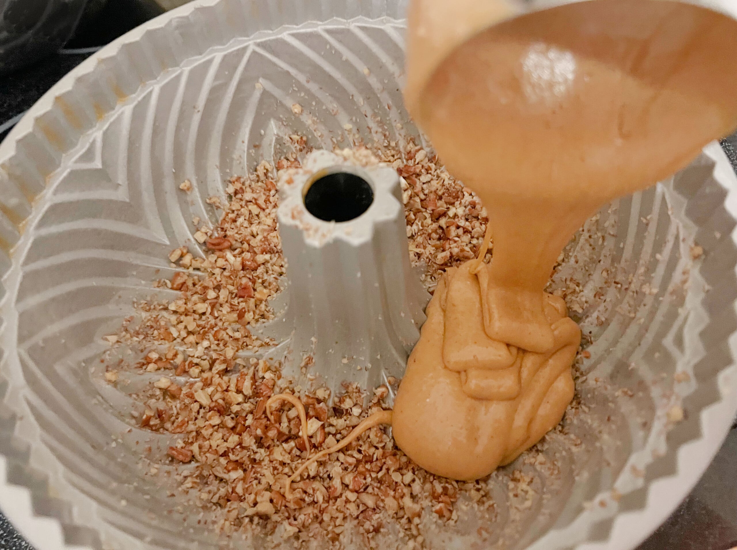 Pouring the sweet potato batter into the bundt cake pan.