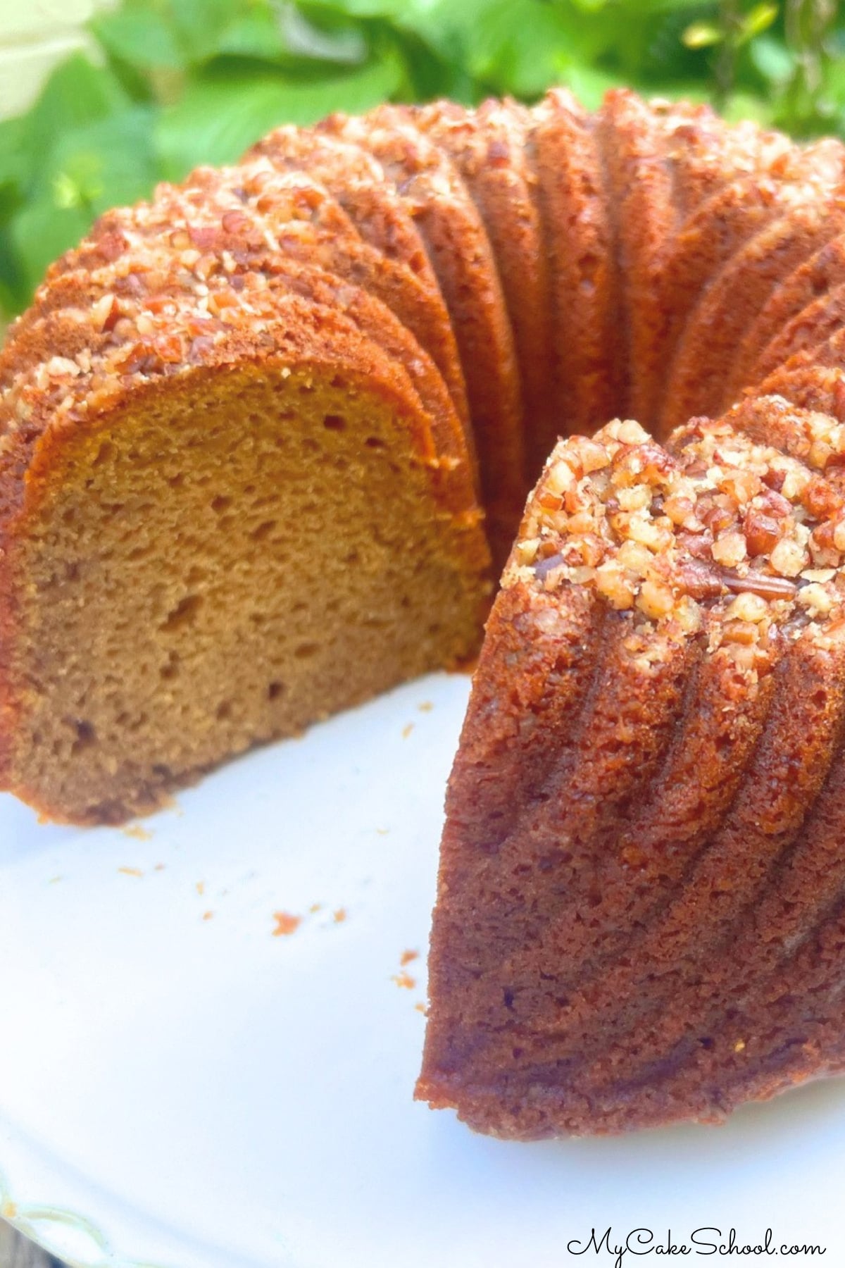 Sliced sweet potato bundt cake from cake mix on a pedestal.