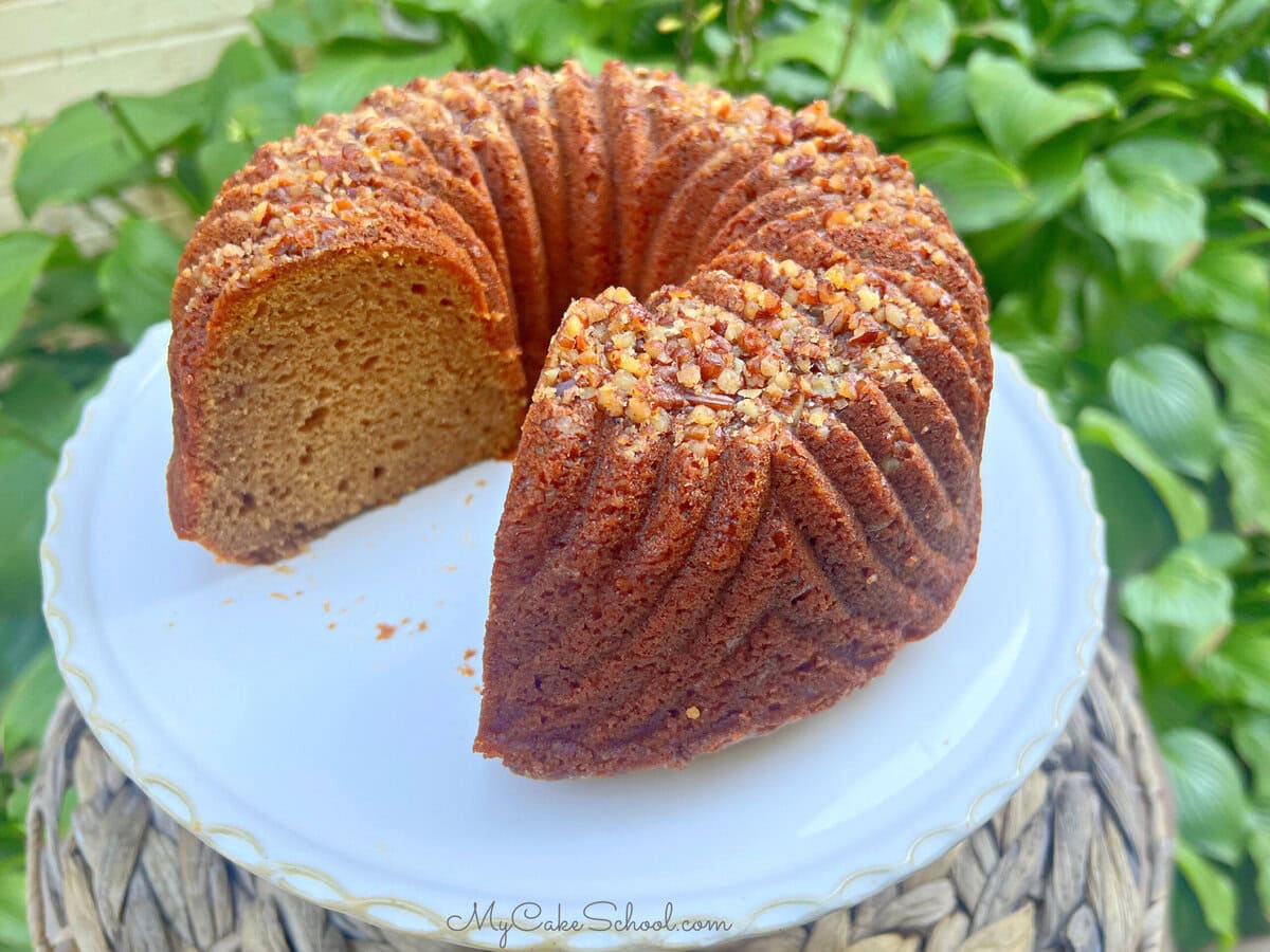 Sweet Potato Bundt Cake, sliced, on a cake pedestal.